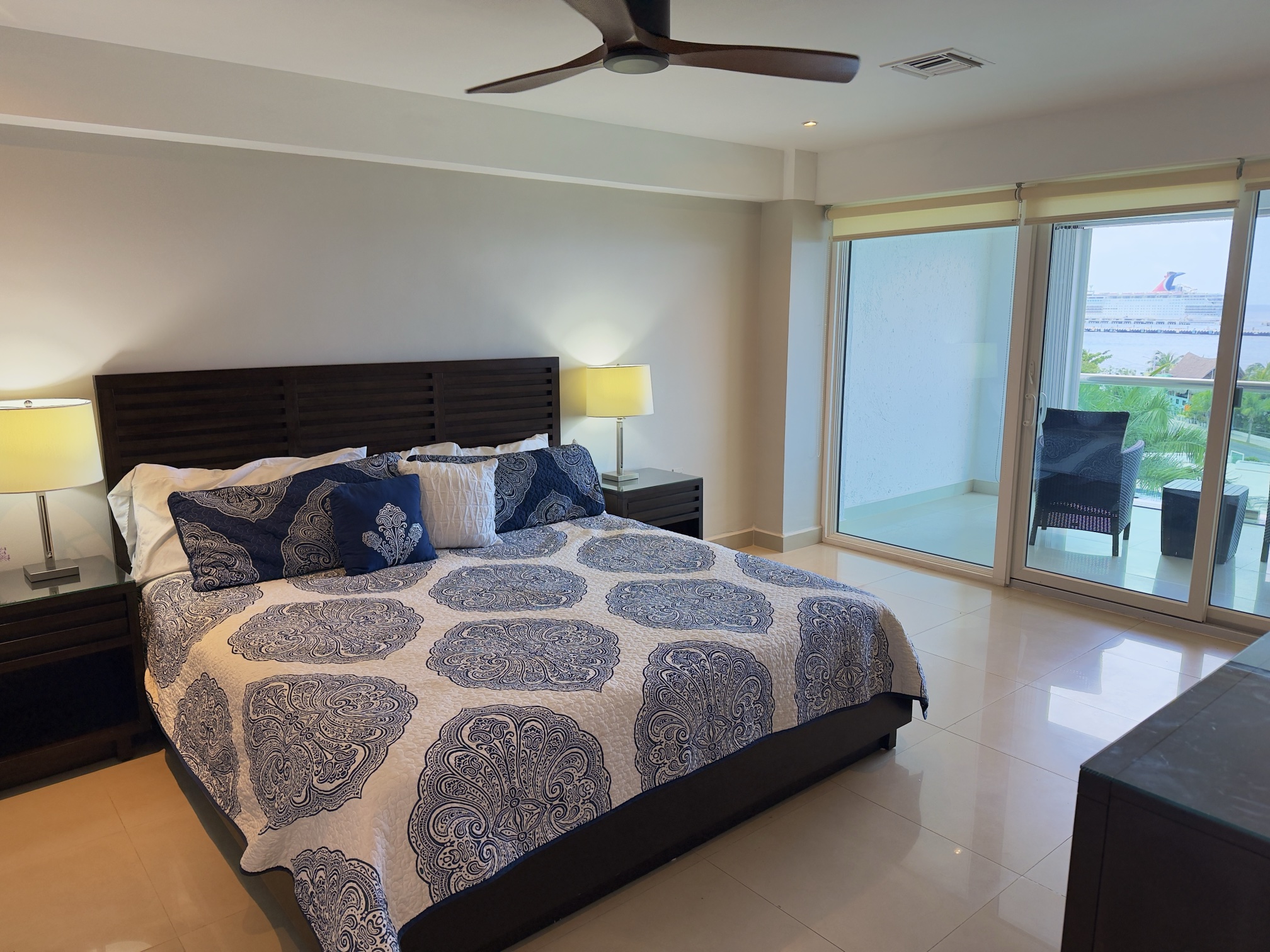 Master bedroom with private balcony and king-size bed
